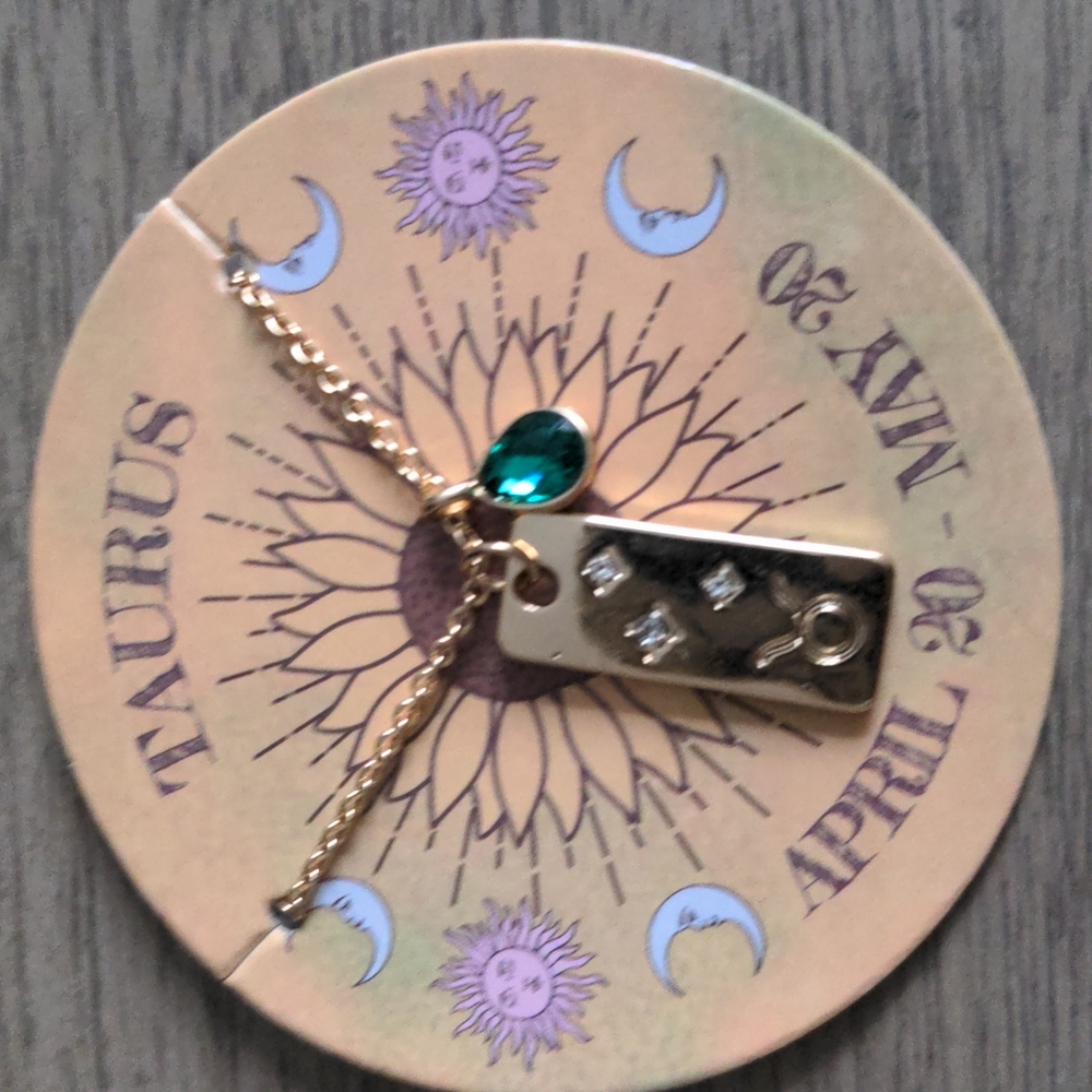 Zodiac Taurus necklace with gold bar, crystal and green stone. New in pkg.